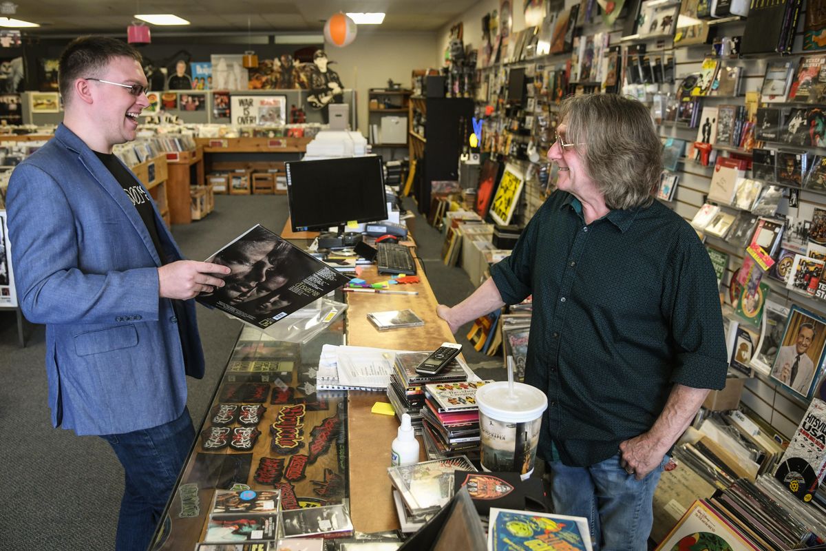 4000 Holes Record Store owner Bob Gallagher was able to make Brandon Neese happy with a vinyl copy of a classic Doors album Thursday, June 19, 2018, in Spokane. Neese is planning to take the record back to Indonesia with him where he teaches English as a second language. (Dan Pelle / The Spokesman-Review)