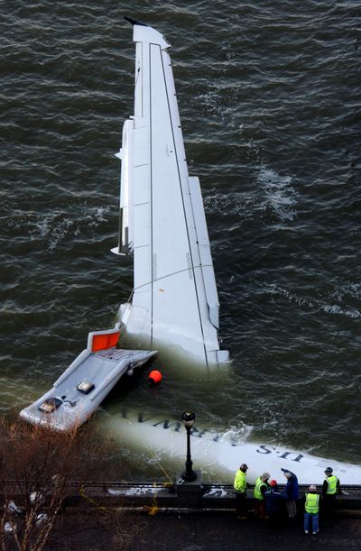 The submerged US Airways plane that crashed into the Hudson River on Thursday was towed to the Manhattan shoreline for inspection Friday.  (Associated Press / The Spokesman-Review)