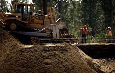 
Workers on Wednesday begin digging up diesel-soaked soil at an Avista tank facility leased by Cenex. 
 (Holly Pickett / The Spokesman-Review)