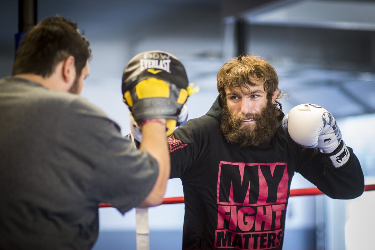UFC fighter Michael Chiesa, right, spars with heavyweight boxer Chauncey Welliver at Boxfit in Spokane. (Colin Mulvany)