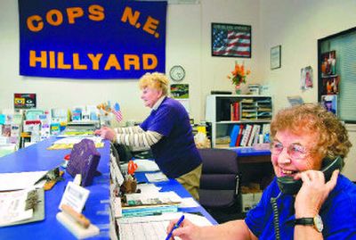 
Dorothy Jilbert, right, and her sister-in-law Donna Jilbert volunteer at the Northeast COPS , the office decked out in Rogers High School colors. 
 (Holly Pickett / The Spokesman-Review)