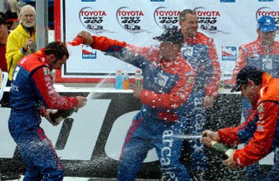 
Dario Franchitti, left, showers teammates with champagne after winning the Indy 400 in Fontana, Calif. 
 (Associated Press / The Spokesman-Review)