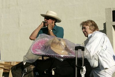 
Tourists David and Mary Horner wait outside the Mexicana Airlines office for their flight to leave Cancun on Friday. 
 (Associated Press / The Spokesman-Review)