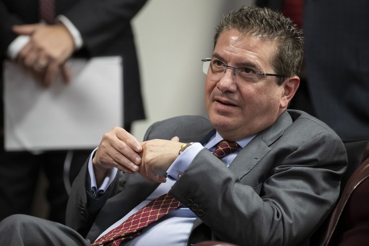 In this Jan. 2, 2020 photo, Washington Redskins owner Dan Snyder listens to head coach Ron Rivera during a news conference at the team