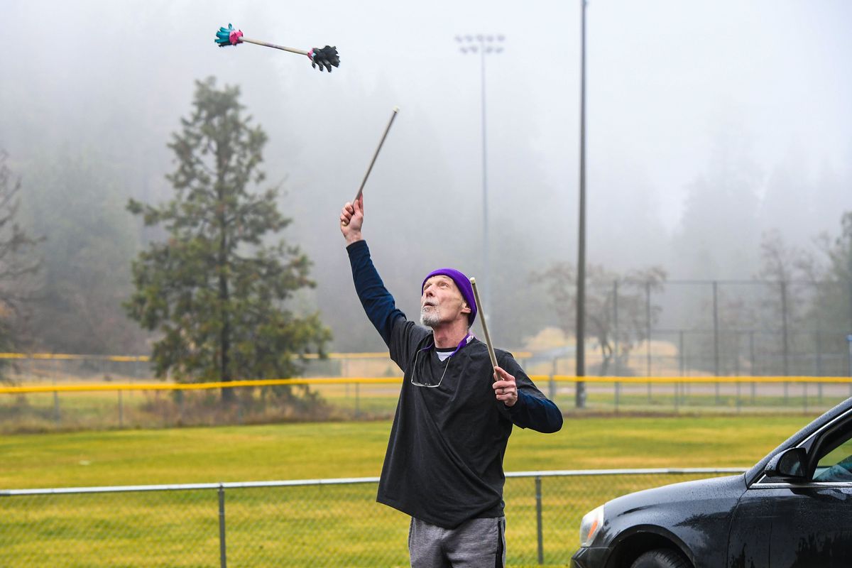 Pat Best tries his best to keep the baton aloft as he works on his Devil Sticks skills, Friday, Nov. 12, 2021, Waterfront Park in Medical Lake. Best started playing with the stick back in 1995, but said he became more serious after getting this new set last Christmas.  (DAN PELLE/THE SPOKESMAN-REVIEW)