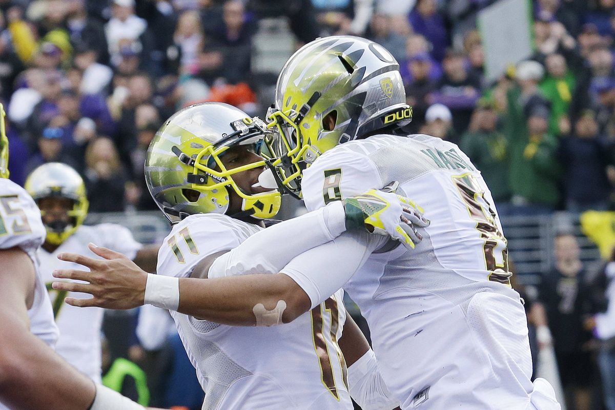 UO’s Marcus Mariota, right, threw for 366 yards, 3 TDs. (Associated Press)