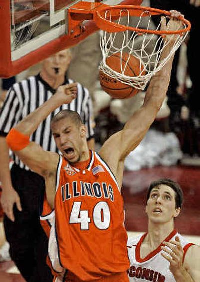 
Illinois' James Augustine slam dunks during Tuesday night's win over Wisconsin. 
 (Associated Press / The Spokesman-Review)