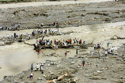 
Stranded by wrecked bridges, people try to cross a river in Tapachula in the southern state of Chiapas, Mexico, on Saturday.
 (Associated Press / The Spokesman-Review)