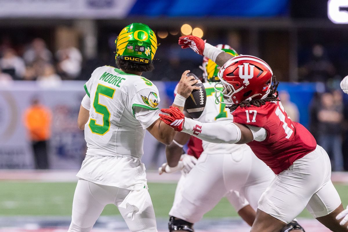 Indiana defensive lineman Daniel Ndukwe (#17) hits Oregon quarterback Dante Moore (#5), knocking the ball loose, as the No. 1 Hoosiers face the No. 5 Oregon Ducks in the Peach Bowl at the College Football Playoff semifinals from Mercedes-Benz Stadium in Atlanta on Friday, Jan. 9, 2025. (Tribune News Service)