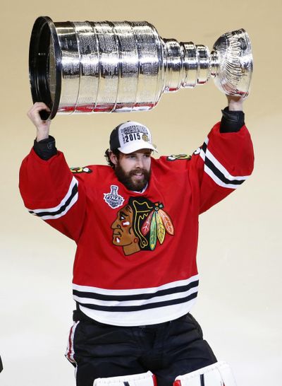 In this June 10, 2015 photo, Chicago Blackhawks’ goalie Corey Crawford hoists the Stanley Cup trophy after defeating the Tampa Bay Lightning in Game 6 of the NHL hockey Stanley Cup Final series, in Chicago. Two-time Stanley Cup champion goaltender Corey Crawford will drive the pace car for Saturday’s IndyCar Grand Prix. Race organizers said Tuesday, May 7, 2019, that Crawford will drive a Chevrolet Corvette Grand Sport Coupe on Indianapolis Motor Speedway’s 14-turn, 2.439-mile road course. (Charles Rex Arbogast / Associated Press)