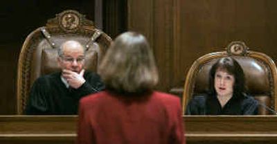 
Washington Supreme Court justices Gerry Alexander, left, and Barbara Madsen, listen to King County attorney Janine Joly's arguments at Wednesday's hearing. 
 (Associated Press / The Spokesman-Review)