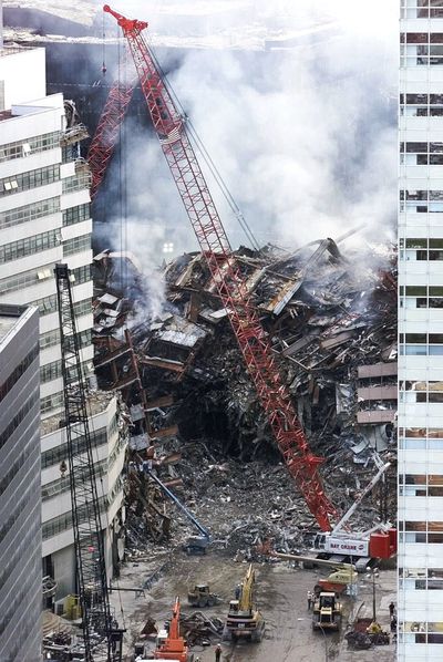 In this Sept. 18, 2001, photo, a crane looms over the smoldering wreckage of World Trade Center building 7 in New York.  (File Associated Press / The Spokesman-Review)