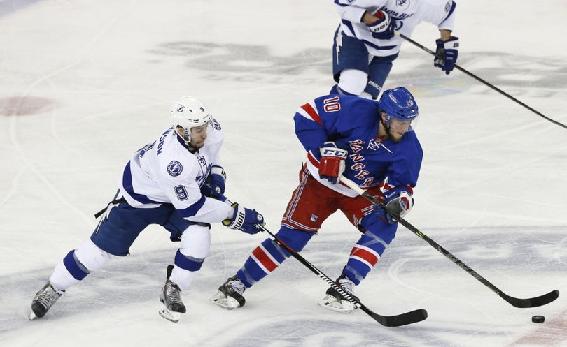 Rangers center J.T. Miller, right, maintains control of the puck as Lightning center Tyler Johnson defends. (Associated Press)