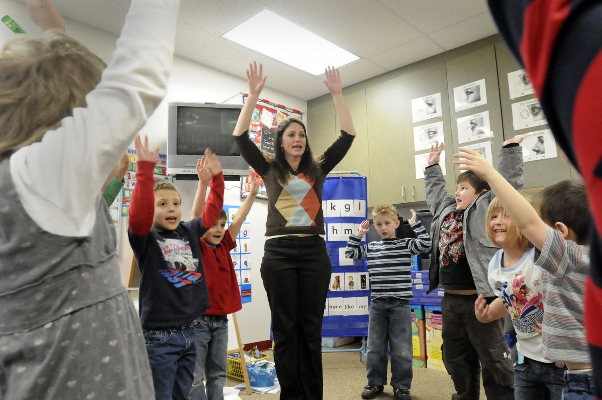 Kindergarten teacher Susan DeGraw leads her class in a stretching exercise after a writing lesson  Wednesday. The kids are, from left, Braeden Pritchett, Wyatt Holloway, Cole Graham, Torrin Knowles, Chelsey Miller and Dante Holverson.  (Jesse Tinsley / The Spokesman-Review)