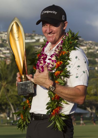 Jimmy Walker shows off the Sony Open trophy after winning in Honolulu. (Associated Press)