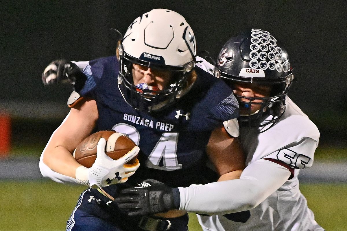 Mt. Spokane’s Daren Airey tackles Gonzaga Prep’s Nick Bankey during the first half of Friday’s Greater Spokane League 4A/3A game at Gonzaga Prep.  (James Snook)