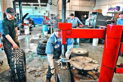
 Perfection Tire, 604 E. Second Ave., has four employees changing tires on Friday. The Spokane shop was expecting to change about 300 sets of studded snow tires that day. Today is the last day for legal use of studded tires in Washington. In Idaho, the deadline is April 15.
 (Photos by JED CONKLIN / The Spokesman-Review)