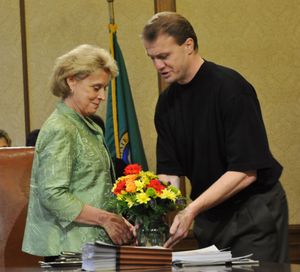 Gov. Chris Gregoire accepts a bouquet of flowers from initiative sponsor Tim Eyman at a bill signing ceremony in Olympia on Wednesday.
 (Jim Camden/The Spokesman-Review)