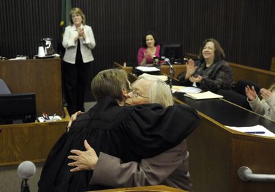 Judge Sara Derr gives Kathleen Wheaton  a hug of after Wheaton received her diploma after graduation from the Spokane County mental health court Wednesday.   (Dan Pelle / The Spokesman-Review)