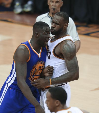 Golden State Warriors forward Draymond Green, who was suspended Sunday for Game 5, and Cleveland Cavaliers forward LeBron James, right, have words during the second half of Game 4. (Ron Schwane / Associated Press)