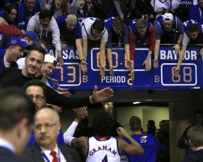 Fans celebrate with Kansas guard Devonte’ Graham (4) and teammates following an NCAA college basketball game Baylor in Lawrence, Kan., Wednesday, Feb. 1, 2017. Kansas defeated Baylor 73-68. (Orlin Wagner / Associated Press)