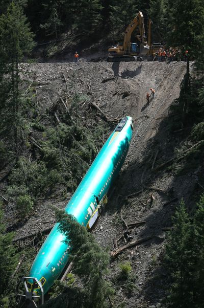 Work crews remove one of the fuselages Monday. (Joshua Trujillo)