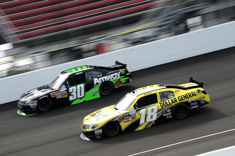 James Buescher, driver of the No. 30 Amway/Gaddes Foundation Chevrolet, and Joey Logano, driver of the No.18 Dollar General Toyota, race during the NASCAR Nationwide Series Alliance Truck Parts 250 at Michigan International Speedway on Saturday in Brooklyn, Mich. (Photo Credit: Jared C. Tilton/Getty Images) (Jared Tilton / Getty Images North America)