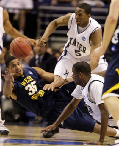 
West Virginia's Wellington Smith attempts to pass as he falls. Associated Press
 (Associated Press / The Spokesman-Review)