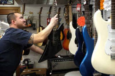
Jeff Salpeter of Spokane Valley finds a guitar to his liking at Shamrock Pawn Shop Friday afternoon. 
 (Holly Pickett / The Spokesman-Review)