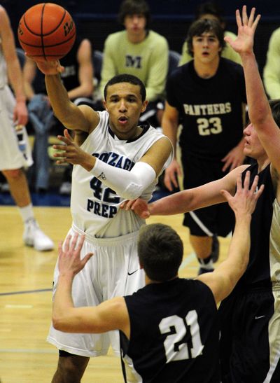 Gonzaga Prep's Jamil Foster makes a pass over Mead's Josh Richter during first-half GSL action on Tuesday. (Colin Mulvany)