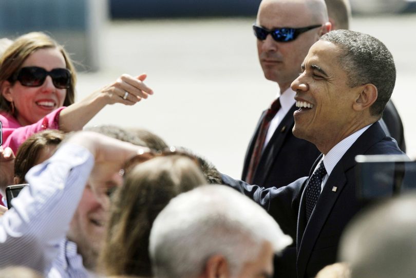 Obama greets supporters upon his arrival. (Associated Press)