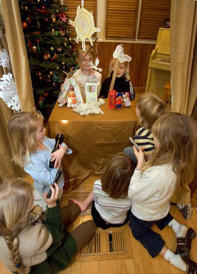 From left, Sage Thomas, 8, and Kate Blickenstaff, 7, perform their makeshift puppet show for neighborhood kids at Wendy Blickenstaff's home in north Boise.
(Associated Press / The Spokesman-Review)