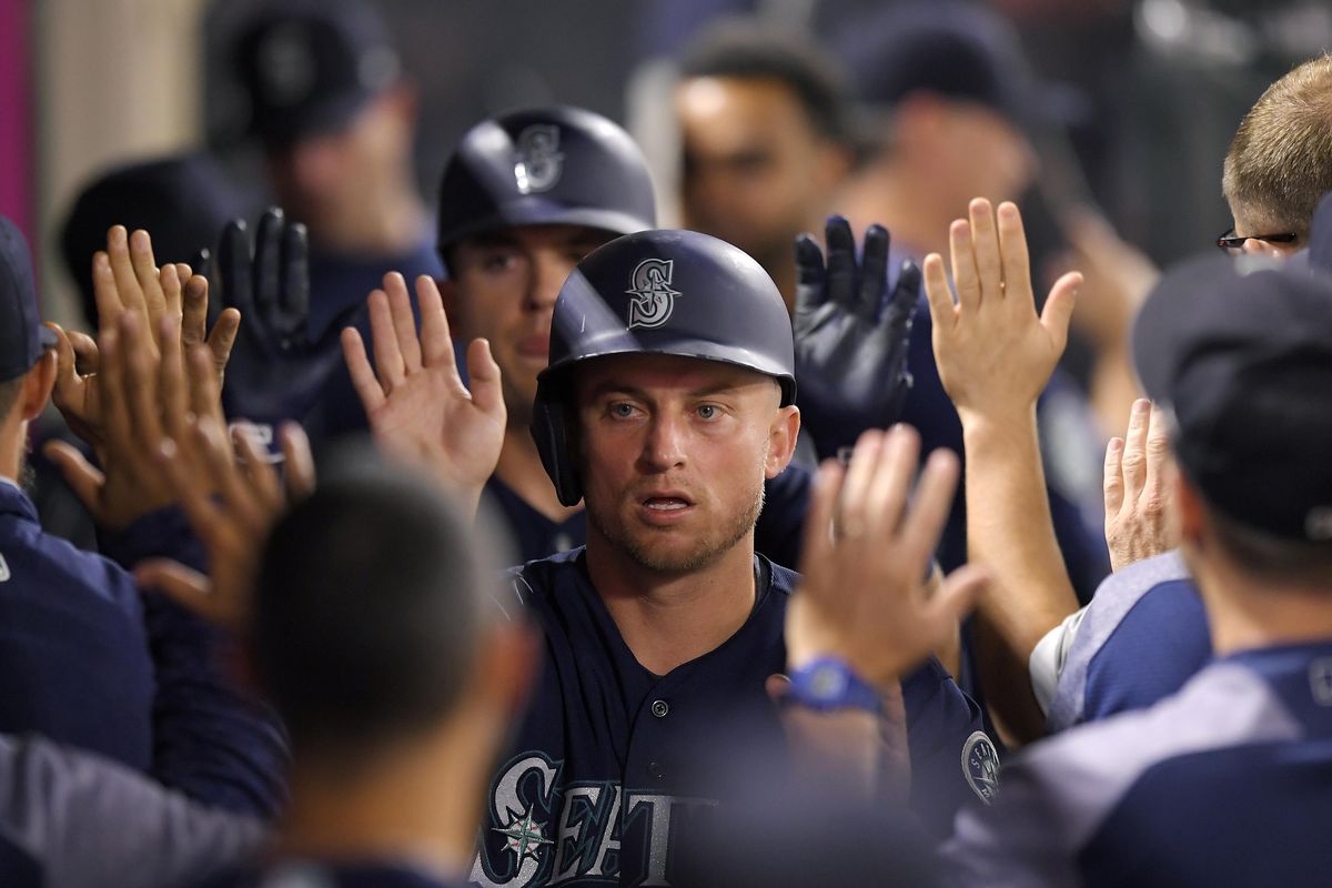 Seattle’s Kyle Seager is congratulated by teammates in the dugout after scoring on a single by Dee Gordon during the seventh inning against the Los Angeles Angels on Friday in Anaheim, Calif. (Mark J. Terrill / AP)