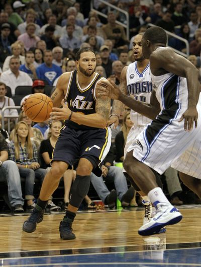 Utah’s Deron Williams, left, moves around Orlando’s defense.  (Associated Press)