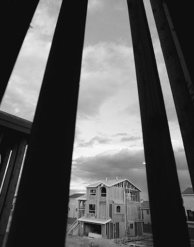 A new home is photographed through another framed-in home in the America West Homes' Kingsbridge development at Coronado Ranch in southwest Las Vegas. The economic recovery is finally spreading to all parts of the country. 