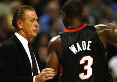 
Miami Heat coach Pat Riley talks to Dwyane Wade during the first quarter of Riley's first game back on the sidelines a day after Stan Van Gundy resigned. 
 (Associated Press / The Spokesman-Review)