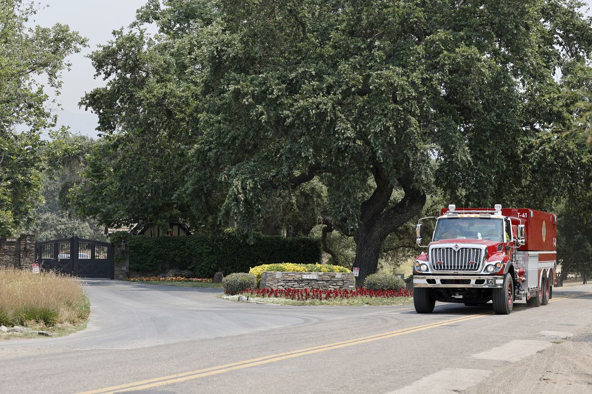 A fire truck is seen near the entrance to Neverland Ranch, former home of late US singer Michael Jackson, as the Lake Fire continues to burn in the Los Padres National Forest, in Los Olivos, California, on July 7, 2024. The fire which began late July 5 near Zaca Lake has spread to over 16,000 acres (6,500 hectares) in Santa Barbara County, prompting evacuation warnings, according to county officials.   (Daniel Dreifuss/AFP/GETTY IMAGES NORTH AMERICA/TNS)