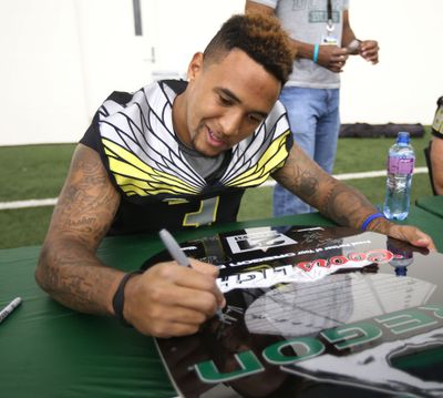 Vernon Adams signs autographs at Oregon Fan Day on Saturday in Eugene. (Chris Pietsch / Eugene Register-Guard)