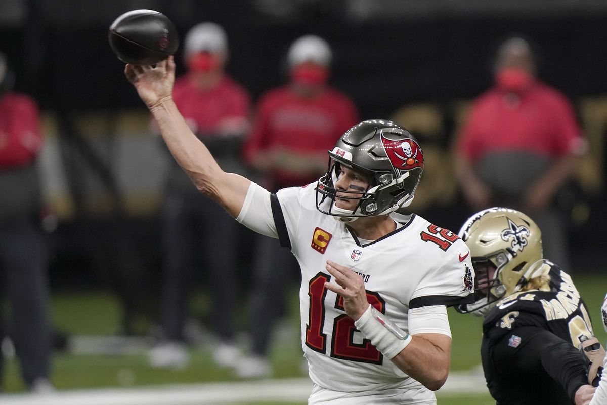 Tampa Bay Buccaneers quarterback Tom Brady (12) works against the New Orleans Saints during the first half of an NFL divisional round playoff football game, Sunday, Jan. 17, 2021, in New Orleans.  (Brynn Anderson)