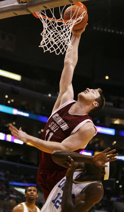 FILE - Washington State's former player Aron Baynes, from Australia, dunks the ball during the first half of an NCAA college basketball game at the Pac-10 men's tournament in Los Angeles in March 2009. (Danny Moloshok / Associated Press)