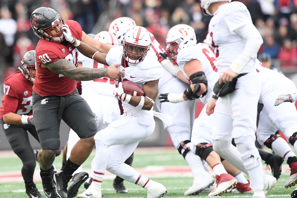 Washington State Cougars defensive lineman Daniel Ekuale (90) stops Stanford Cardinal running back Bryce Love (20) during the first half of a college football game on Saturday, November 4, 2017, at Martin Stadium in Pullman, Wash. WSU led 14-7 at the half. (Tyler Tjomsland / The Spokesman-Review)