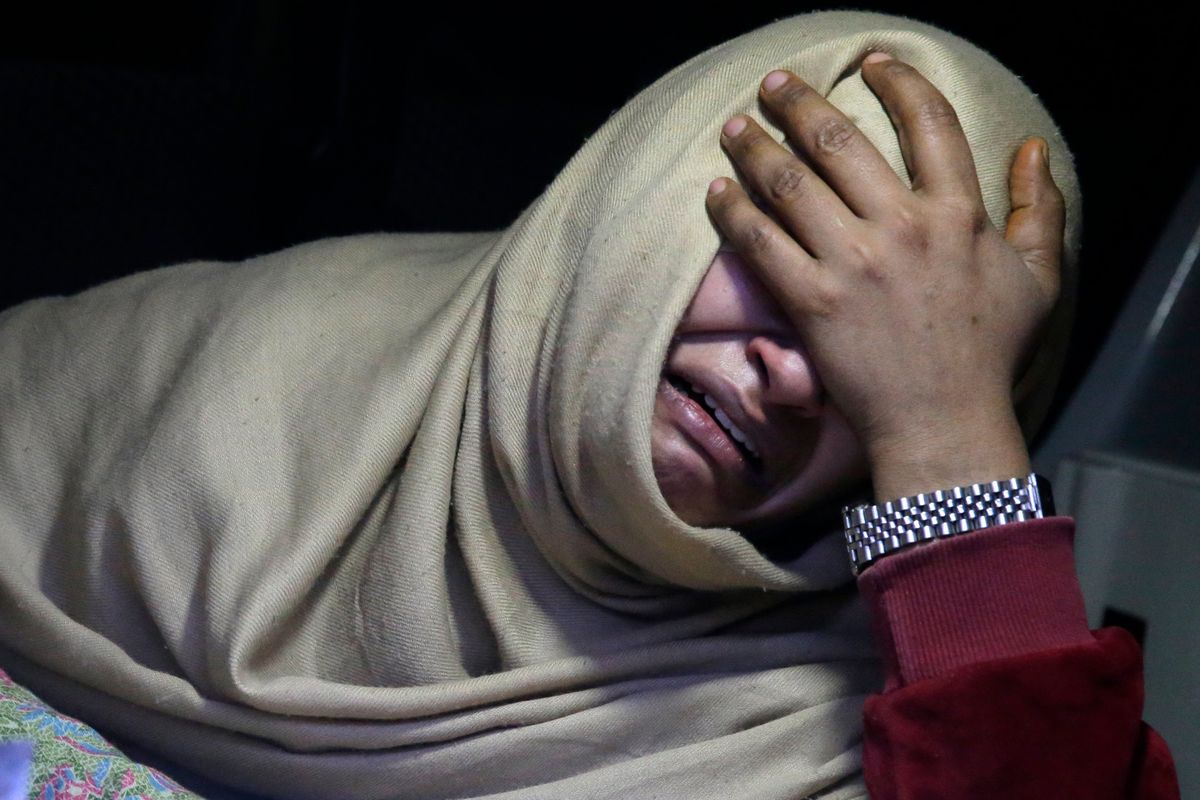 A woman cries inside an ambulance after she lost a family member in the snowstorm in Pakistan.  (Rahmat Gul)