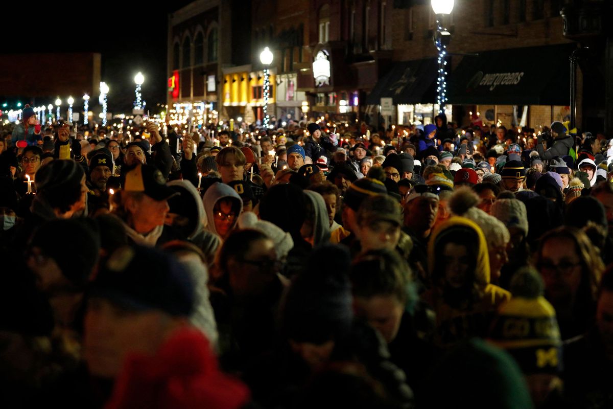People gather for a candlelight vigil for the victims of the Oxford High School shooting in downtown Oxford Township, Mich., on Dec. 3, 2021.  (Jeff Kowalsky/AFP/Getty Images North America/TNS)