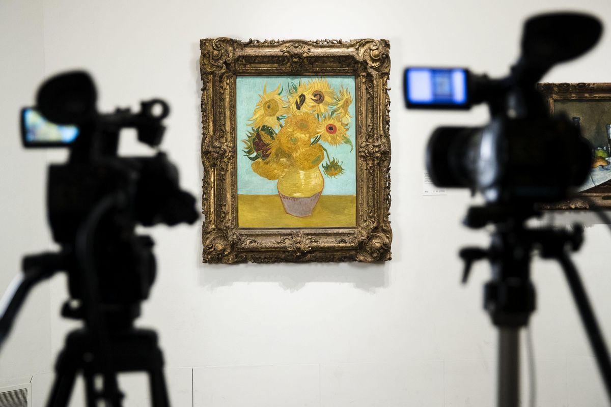 Cameras are set to broadcast Vincent van Gogh’s “Sunflowers” at the Philadelphia Museum of Art in Philadelphia, Monday, Aug. 14, 2017. Five versions of the  van Gogh masterpiece are being reunited for the first time in a “virtual exhibition.” Van Gogh painted his “Sunflowers” series in the south of France in 1888 and 1889. On Monday they will all be streamed to a global audience in a Facebook Live broadcast that starts at London’s National Gallery and continues at museums in Amsterdam, Munich, Philadelphia and Tokyo. (Matt Rourke / Associated Press)