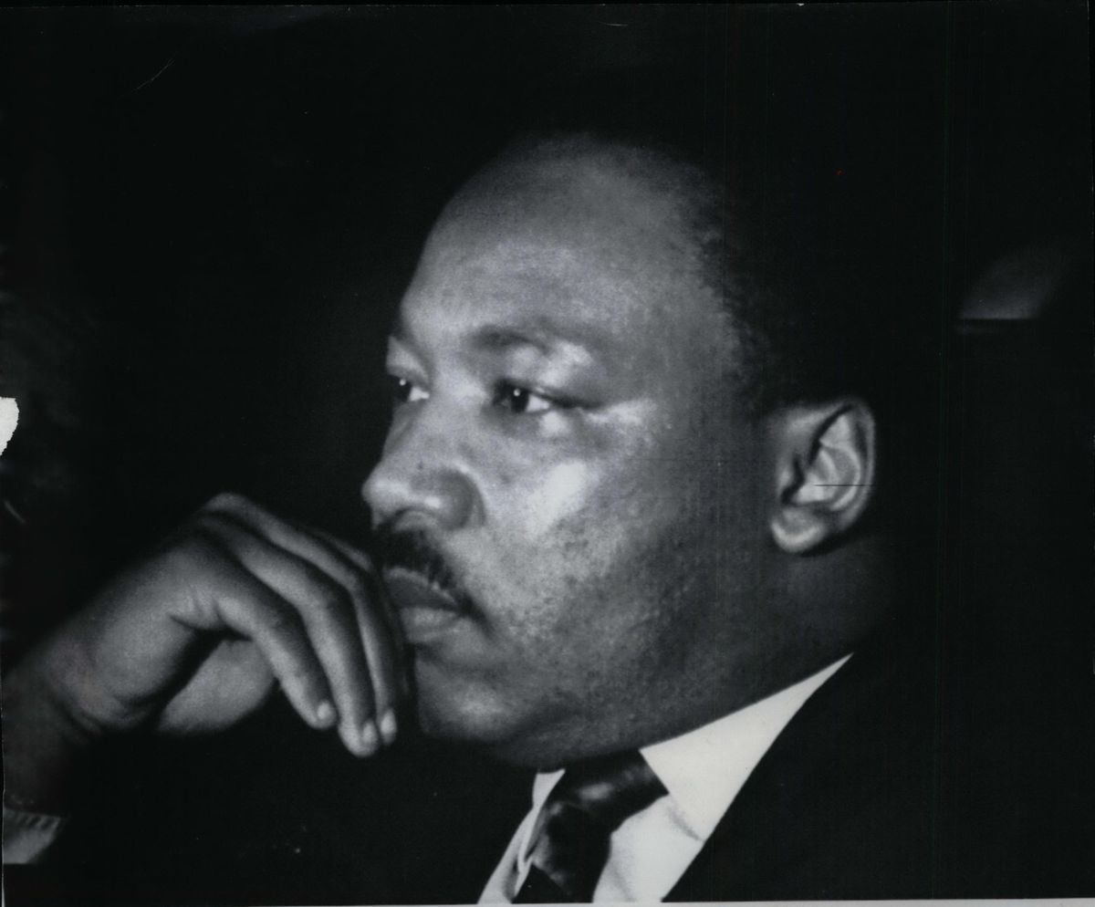 Dr. Martin Luther King strokes his chin before addressing a mass rally for striking Memphis sanitation workers. It was Dr. King