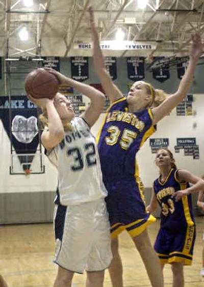 
Lake City's Amy Lawson, left, draws a foul from Lewiston's Lisa Cannon in a 5A Region I playoff game Tuesday night. 
 (Tom Davenport/ / The Spokesman-Review)