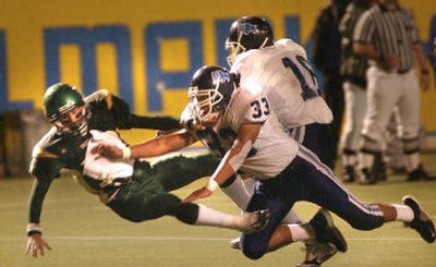 
Gonzaga Prep linebacker Vince Tschirgi (33) levels Shadle Park quarterback Clay Scribner, but not before Scribner completed a pass for a first down on Friday night.
 (Brian Plonka / The Spokesman-Review)