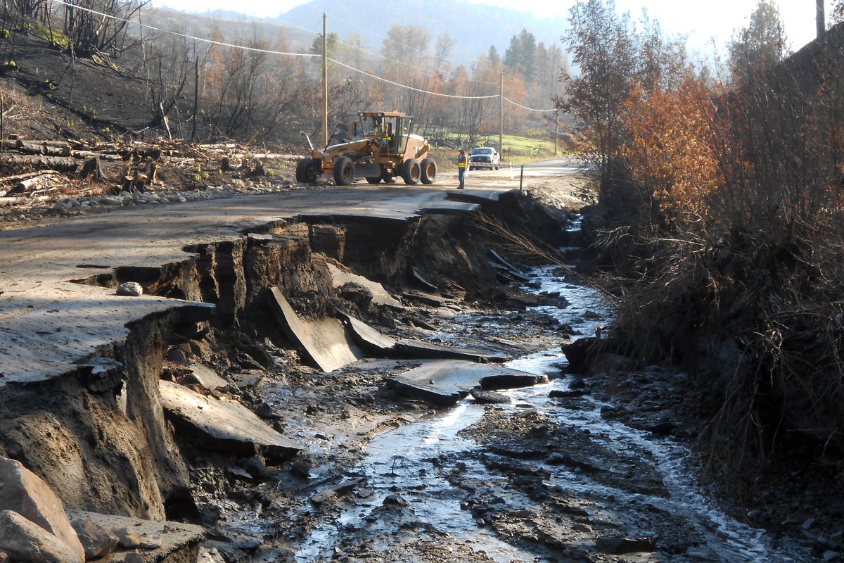 State Department of Transportation crews work Friday near a damaged road east of Twisp, Wash. (Associated Press)