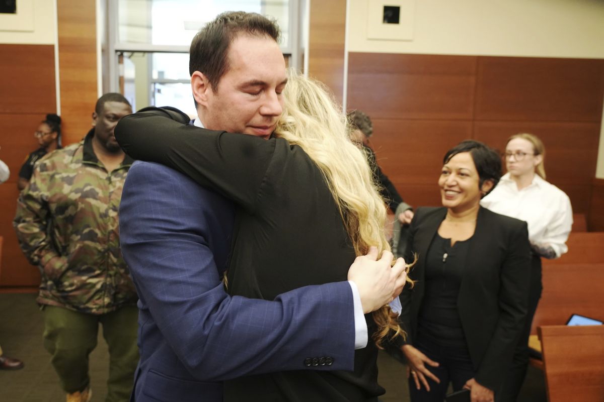 Former Mount Carmel Health doctor William Husel hugs his wife, Mariah Baird, after he was found not guilty on 14 counts of murder in connection with fentanyl overdose deaths of former patients on Wednesday, April 20, 2022 in Columbus, Ohio. Husel was accused of ordering excessive painkillers for 14 patients in the Mount Carmel Health System. He was indicted in cases that involved at least 500 micrograms of the powerful painkiller fentanyl.  (Doral Chenoweth)