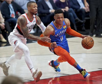 Oklahoma City Thunder guard Russell Westbrook, right, dribbles past Portland Trail Blazers guard Damian Lillard during the first half of Game 2 of an NBA basketball first-round playoff series Tuesday, April 16, 2019, in Portland, Ore. (Craig Mitchelldyer / Associated Press)